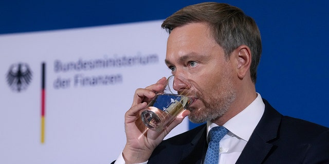 German Finance Minister Christian Lindner drinks water before he addresses the media during a press conference after a meeting of the stability council in Berlin, Germany, Friday, Dec. 10, 2021. 