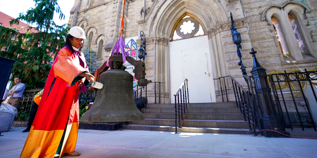 Senior Minister Rev. Jacqueline J. Lewis rings New York's Liberty Bell after a crew lowered it from Middle Collegiate Church's bell tower on June 16, 2021, in the East Village neighborhood of New York.