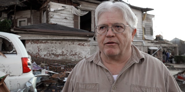 Mayfield, Kentucky resident Tommy Anderson stands in front of his home