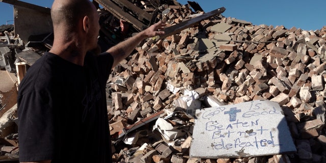 Brooks shows the type of rubble he had to climb, and jump through to get to his wife
