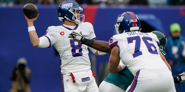 New York Giants quarterback Daniel Jones throws under pressure during the first half of an NFL football game against the Philadelphia Eagles, Sunday, Nov. 28, 2021, in East Rutherford, N.J.
