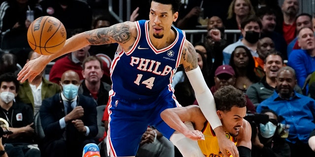 Atlanta Hawks guard Trae Young, right, knocks the ball away from Philadelphia 76ers forward Danny Green (14) during the first half of an NBA basketball game Friday, Dec. 3, 2021, in Atlanta.