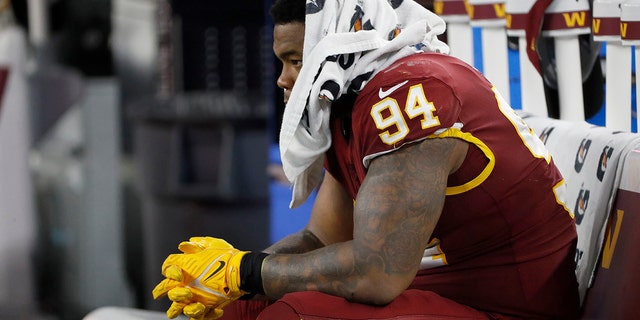 Washington Football Team defensive tackle Daron Payne sits on the bench in the second half of an NFL football game against the Dallas Cowboys in Arlington, Texas, Sunday, Dec. 26, 2021.