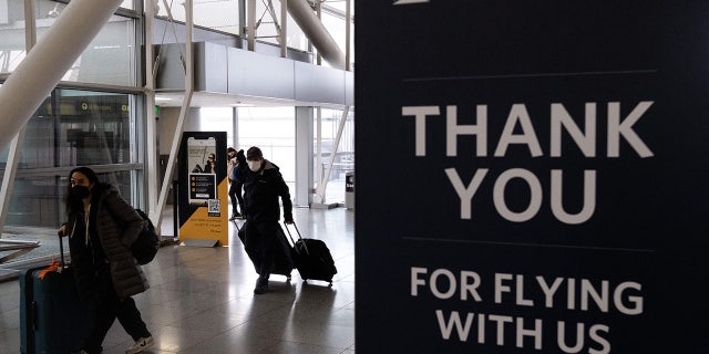 FILE: Dr. Anthony Fauci said in an interview Sunday that passengers should continue to wear masks on planes. (Photo by Yuki IWAMURA / AFP) (Photo by YUKI IWAMURA/AFP via Getty Images)