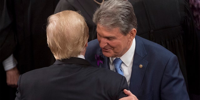 President Trump embraces Sen. Joe Manchin after the State of the Union address at the U.S. Capitol op Jan.. 30, 2018.