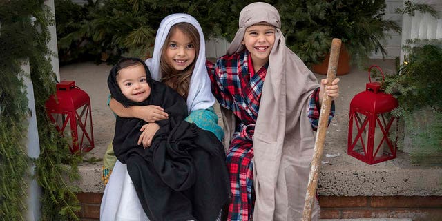 Some of the Duffy children are shown honoring the true meaning of the Christmas season. This photo and many others appear in ‘All American Christmas.'