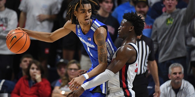 Memphis forward Emoni Bates looks for room past Mississippi guard Jarkel Joiner in Oxford, Mississippi, Saturday, Dec. 4, 2021.