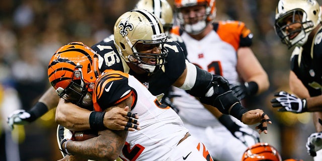 Glenn Foster, #97 of the New Orleans Saints, tackles Jeremy Hill, #32 of the Cincinnati Bengals, during the second half against the New Orleans Saints at Mercedes-Benz Superdome on Nov. 16, 2014 in New Orleans.