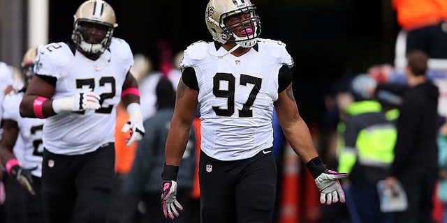 Defensive end Glenn Foster, #97 of the New Orleans Saints, takes the field before the start of the Saints and New England Patriots game at Gillette Stadium on Oct. 13, 2013 in Foxboro, Massachusetts.