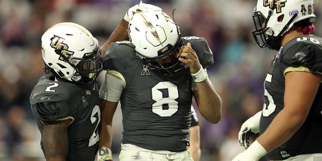 GLENDALE, ARIZONA - JANUARY 01: Running back Otis Anderson #2 hugs teammate quarterback Darriel Mack Jr. #8 of the UCF Knights during the fourth quarter of the PlayStation Fiesta Bowl between LSU and Central Florida at State Farm Stadium on January 01, 2019 in Glendale, Arizona.