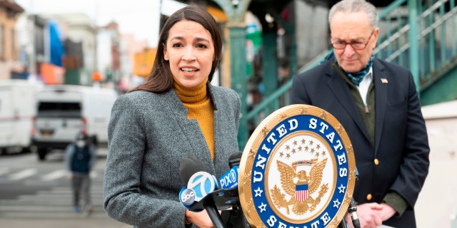 Democratic Rep. Alexandria Ocasio-Cortez speaks as Senate Minority Leader Chuck Schumer listens during a press conference in the Corona neighborhood of Queens on April 14, 2020, in New York City.