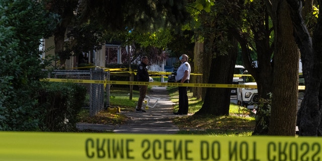 Police officers examine a crime scene following a shooting at a backyard party September 19, 2020 in Rochester, New York.