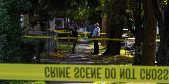 Police officers investigate a crime scene after a shooting at a backyard party Sept. 19, 2020, in Rochester, New York.