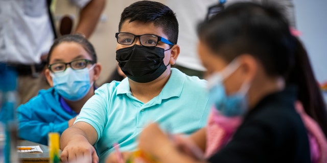  Third grade dual language students wear masks as they listen to instruction while Los Angeles Unified Interim Superintendent Megan K. Reilly