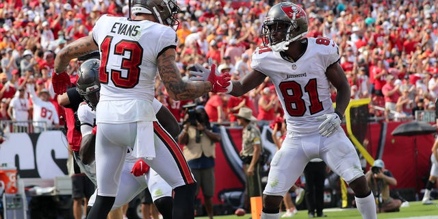 Tampa Bay Buccaneers receiver Mike Evans (13) is congratulated for scoring a touchdown by Antonio Brown (81) during a game between the Miami Dolphins and the Tampa Bay Buccaneers Oct. 10, 2021, at Raymond James Stadium in Tampa, Florida. 