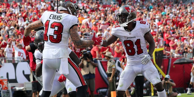 Tampa Bay Buccaneers receiver Mike Evans (13) is congratulated for scoring a touchdown by Antonio Brown (81) during a game between the Miami Dolphins and the Tampa Bay Buccaneers Oct. 10, 2021, at Raymond James Stadium in Tampa, Florida. 