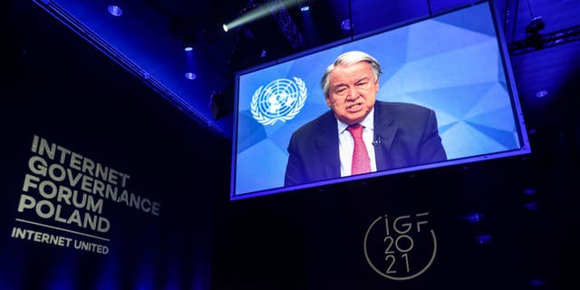 United Nations Secretary-General Antonio Guterres is shown on the screen while speaking at the opening ceremony of the UN Internet Governance Forum in Katowice, Poland on Dec. 7, 2021. 