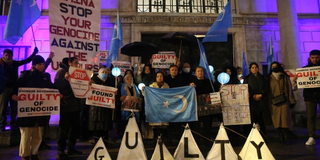 People stage a protest in front of the Chinese Embassy after the Uyghur Tribunal ruled that China committed genocide against Uyghurs and other ethnic minorities through policies such as coerced birth control and sterilization in London, United Kingdom, on Dec. 9, 2021. 