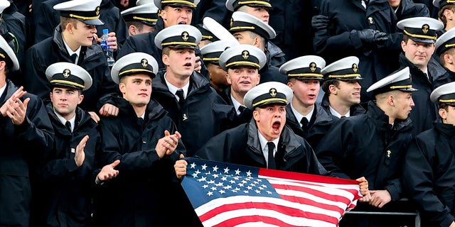 Navy Midshipmen in the stands with an American Flag during the 122nd Army/Navy college football game between the Army Black Knights and the Navy Midshipmen on Dec. 11, 2021 at MetLife Stadium in East Rutherford, New Jersey.  