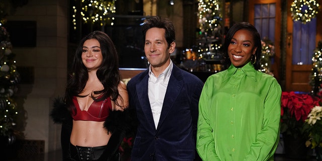 Charli XCX, left, and Paul Rudd stand with cast member Ego Nwodim during promos for "Saturday Night Live" in New York City, Dec. 16, 2021.