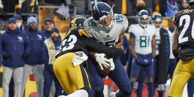 Pittsburgh Steelers cornerback Joe Haden (23) makes a critical fourth down tackle against Tennessee Titans wide receiver Nick Westbrook-Ikhine (15) in the fourth quarter during the game between the Pittsburgh Steelers and the Tennessee Titans on December 19, 2021 at Heinz Field in Pittsburgh, PA. 