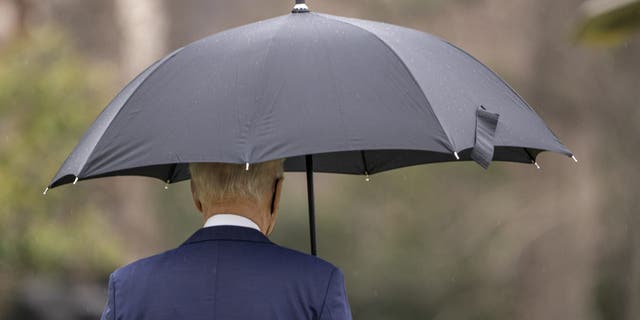 U.S. President Joe Biden walks on the South Lawn of the White House before boarding Marine One in Washington, D.C., U.S., on Monday, Dec. 27, 2021. Biden's medical adviser said a domestic travel vaccination rule should be considered as the omicron variant fuels record Covid-19 case loads in some states and holiday travel continues to be disrupted around the U.S. Photographer: Ken Cedeno/UPI/Bloomberg via Getty Images