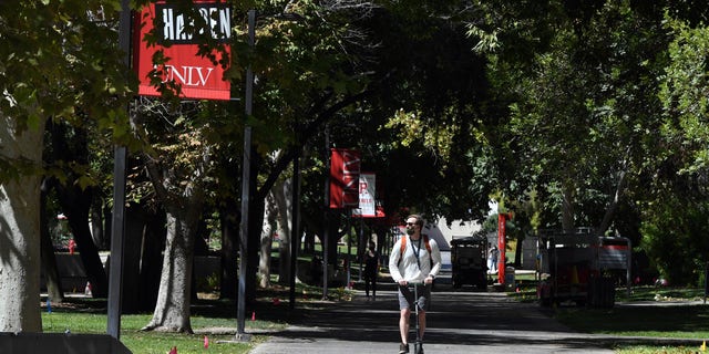 LAS VEGAS, NEVADA - SEPTEMBER 09:  A person rides a scooter on a walkway on campus at UNLV amid the spread of the coronavirus (COVID-19) on UNLV campus on September 9, 2020.