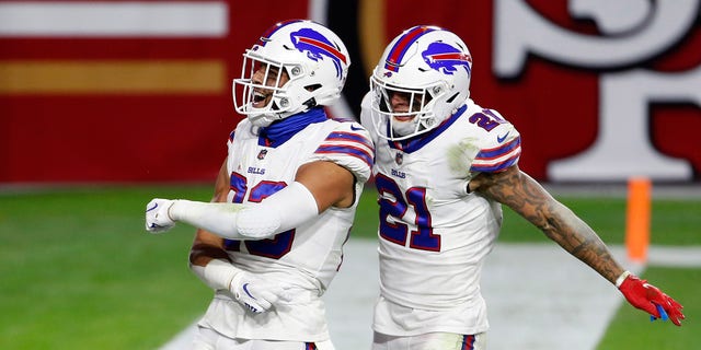GLENDALE, ARIZONA - DECEMBER 07: Safety Micah Hyde #23 of the Buffalo Bills celebrates his interception against the San Francisco 49ers with teammate Jordan Poyer #21 of the Bills during the second half of the NFL football game at State Farm Stadium on December 07, 2020 in Glendale, Arizona. 