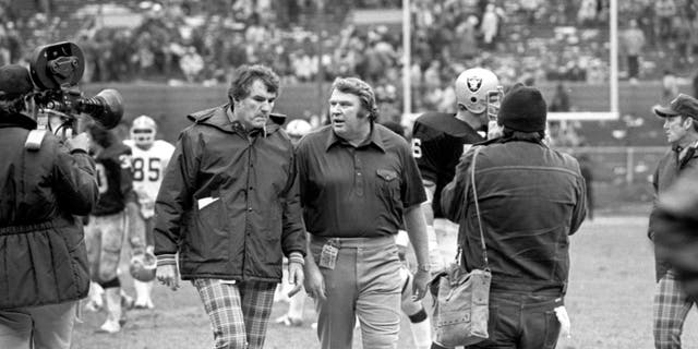 Head coaches Forrest Gregg of the Cleveland Browns (L) and John Madden of the Oakland Raiders walk off the field after a game at Cleveland Municipal Stadium on October 09, 1977 in Cleveland, Ohio. Oakland won 26-10.