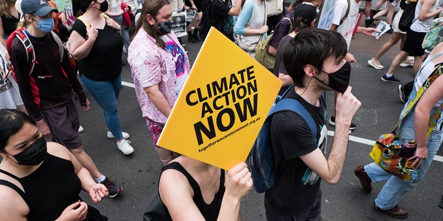 Climate change protestors are seen marching and changing as they carry placards on November 06, 2021 in Melbourne, Australia. (Photo by Asanka Ratnayake/Getty Images)
