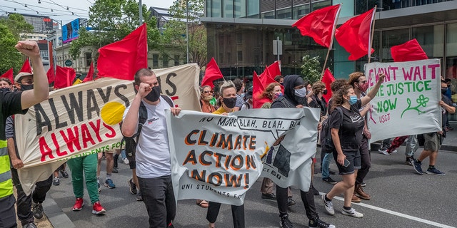 Climate change protestors are seen marching and changing as they carry placards on November 06, 2021 in Melbourne, 澳大利亚.  (Photo by Asanka Ratnayake/Getty Images)