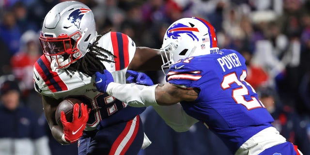 ORCHARD PARK, NEW YORK - DECEMBER 06: Rhamondre Stevenson #38 of the New England Patriots carries the ball as Jordan Poyer #21 of the Buffalo Bills tackles in the third quarter of the game at Highmark Stadium on December 06, 2021 in Orchard Park, New York. 