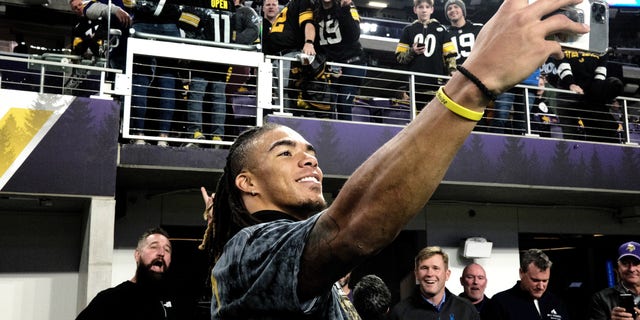 Chase Claypool of the Pittsburgh Steelers takes photos with fans before the game against the Minnesota Vikings at U.S. Bank Stadium on Dec. 9, 2021 in Minneapolis, Minnesota. 