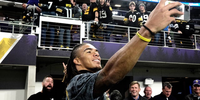 Chase Claypool of the Pittsburgh Steelers takes photos with fans before the game against the Minnesota Vikings at U.S. Bank Stadium on Dec. 9, 2021 in Minneapolis, Minnesota.