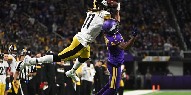 Chase Claypool of the Pittsburgh Steelers catches a pass over Patrick Peterson #7 of the Minnesota Vikings during the third quarter at U.S. Bank Stadium on Dec. 9, 2021 in Minneapolis, Minnesota.