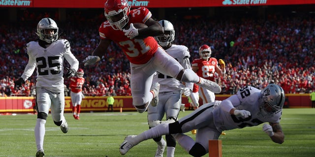 Darrel Williams (31) of the Kansas City Chiefs dives across the goal line for a touchdown during the first quarter against the Las Vegas Raiders at Arrowhead Stadium Dec. 12, 2021, in Kansas City, Missouri.