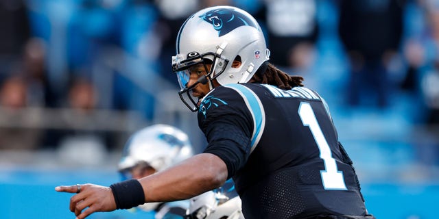 CHARLOTTE, NORTH CAROLINA - DECEMBER 12: Cam Newton #1 of the Carolina Panthers signals prior to a two-point conversion attempt in the fourth quarter of the game against the Atlanta Falcons at Bank of America Stadium on December 12, 2021 in Charlotte, North Carolina. 
