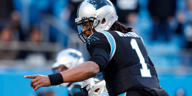 Panthers' Cam Newton signals prior to a two-point conversion attempt against the Atlanta Falcons on Dec. 12, 2021, in Charlotte, North Carolina.
