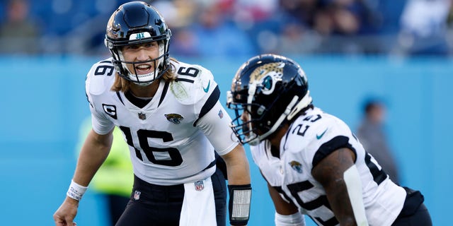 Trevor Lawrence (16) of the Jacksonville Jaguars reacts with James Robinson against the Tennessee Titans during the second half at Nissan Stadium Dec. 12, 2021, a Nashville. 