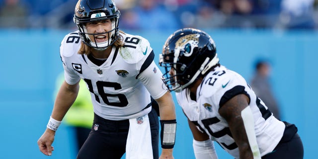 Trevor Lawrence (16) of the Jacksonville Jaguars reacts with James Robinson against the Tennessee Titans during the second half at Nissan Stadium Dec. 12, 2021, a Nashville.