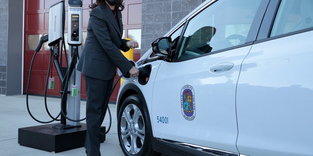 United States Vice President Kamala Harris plugs a Prince George County electric vehicle into a charging station at the Brandywine Maintenance Facility on December 13, 2021 in Brandywine, Maryland.
