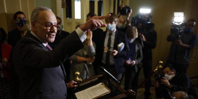 Senate Majority Leader Charles Schumer talks to reporters at the U.S. Capitol on Dec. 14, 2021.