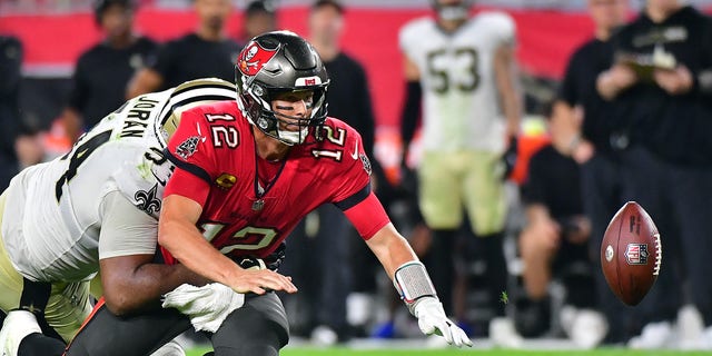 Bucs' quarterback Tom Brady fumbles as he is hit by Cameron Jordan of the New Orleans Saints on Dec. 19, 2021 in Tampa, Florida. 