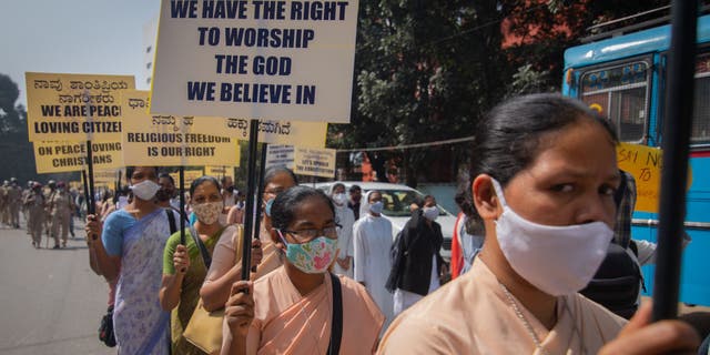 Christian nuns wave banners as they march during a demonstration against the introduction of the Right to Freedom of Religion Protection Bill on December 22, 2021 in Bangalore, India.