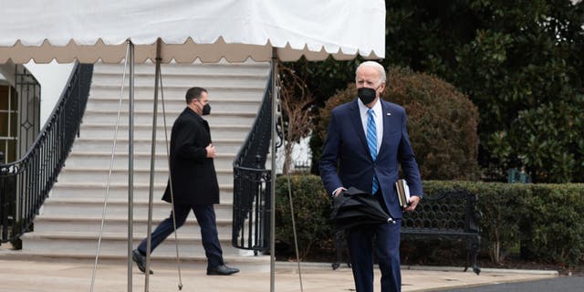 President Biden walks to speak with reporters on the South Lawn before departing from the White House on Marine One on Dec. 27, 2021 in Washington. (Photo by Anna Moneymaker/Getty Images)