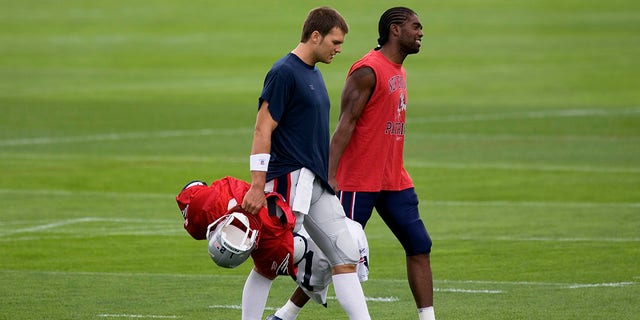 New England Patriots' quarterback Tom Brady (left) and wide receiver Randy Moss walk toward the Dana Farber Field House at Gillette Stadium at the beginning of their first day of practice in Foxborough, Mass. July 24, 2008.  