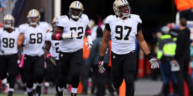 Defensive end Glenn Foster (97) of the New Orleans Saints takes the field before the start of the Saints and New England Patriots game at Gillette Stadium on Oct. 13, 2013, in Foxboro, Massachusetts.