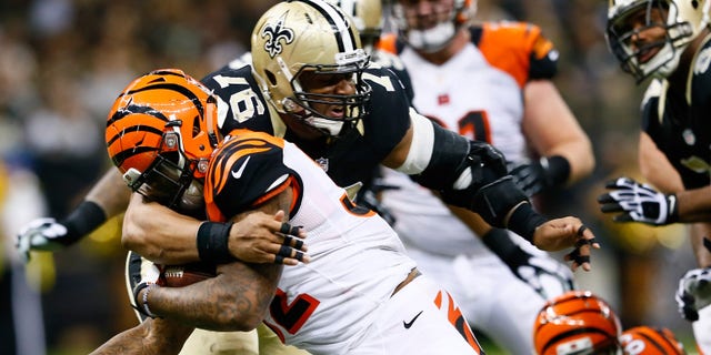 Glenn Foster (97) of the New Orleans Saints tackles Jeremy Hill (32) of the Cincinnati Bengals during the second half against the New Orleans Saints at Mercedes-Benz Superdome on Nov. 16, 2014, in New Orleans, Louisiana.