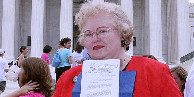 Sarah Weddington, an attorney who argued the winning side of the landmark case Roe v. Wade, to make abortion legal, before the United States Supreme Cour, poses with a signed copy of the decision in front of the US Supreme Court 27 June, 2005.