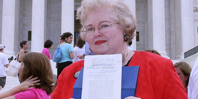 Sarah Weddington, an attorney who argued the winning side of the landmark case Roe v. Wade, to make abortion legal, before the United States Supreme Cour, poses with a signed copy of the decision in front of the US Supreme Court 27 June, 2005.